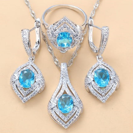 Oorringe met juweelinlegsel, hangertjie, halssnoer, ring Drie-stuk stel vir dames