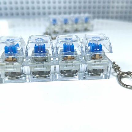 4 Sleutels Meganiese Sleutelbord Elektroniese Liggende Deursigtige Kristal Hoogte Drukvermindering Vingerknoppie Anti-Stres Sleutelknop Speelding Skooltassleutelhanger Dekompressie Klikker Gadget Geskenk