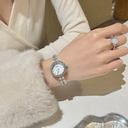 Damesarmband oesjaar varswater pêrelhorlosie
