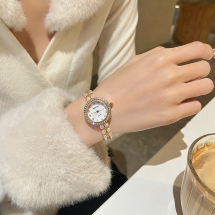 Damesarmband oesjaar varswater pêrelhorlosie