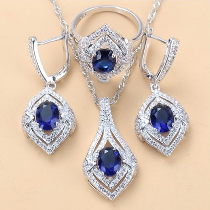 Oorringe met juweelinlegsel, hangertjie, halssnoer, ring Drie-stuk stel vir dames